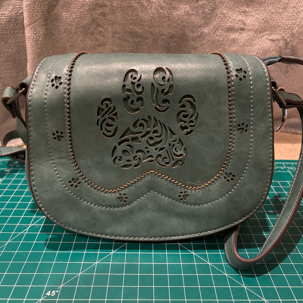 Greater Good animal rescue teal paw print saddle bag